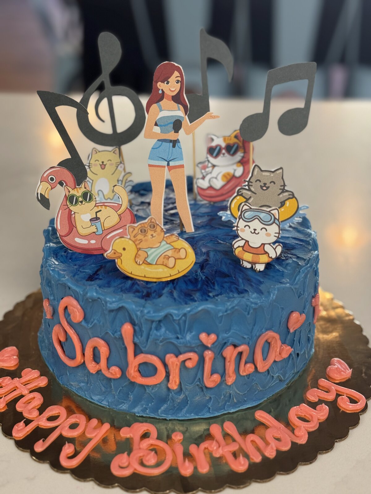 Cartoon cats on a pool float birthday cake at Lu's