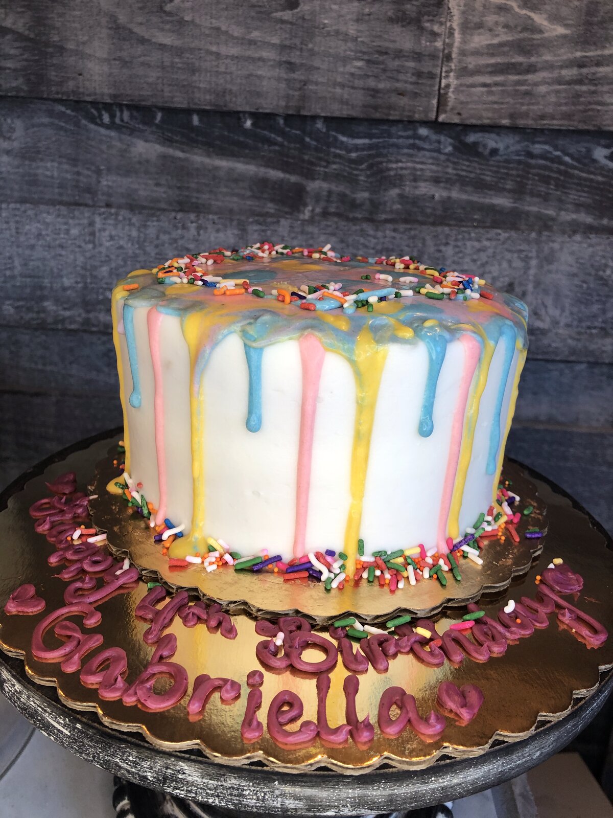 Pastel drip birthday cake with sprinkles at Lu's