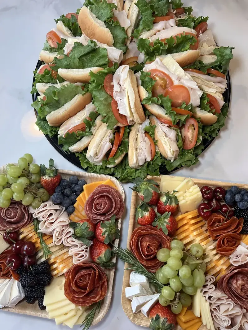 Turkey sandwich platter with three charcuterie trays for an event catered by Lu's Cafe & Bakery