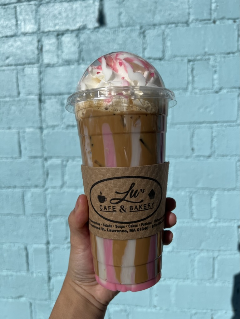 Pink drizzle iced latte with whipped cream at Lu's Cafe & Bakery