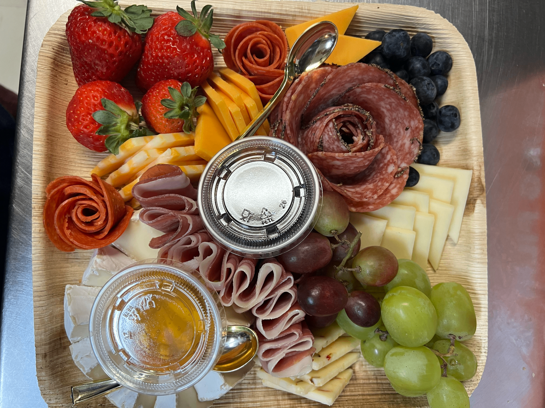 Charcuterie board with fruit, meats & cheeses