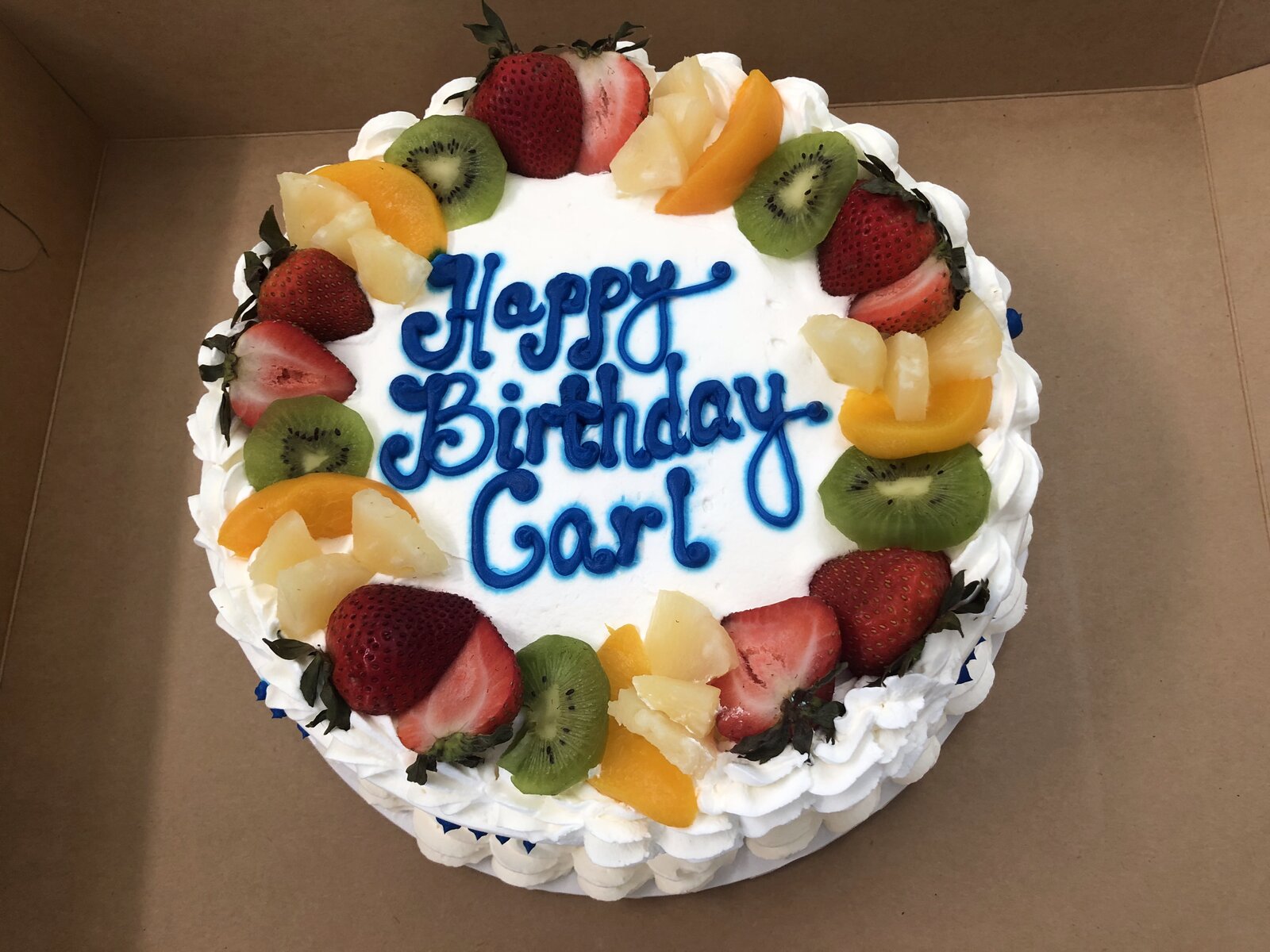 Fresh-fruit-topped birthday cake at Lu's Cafe & Bakery